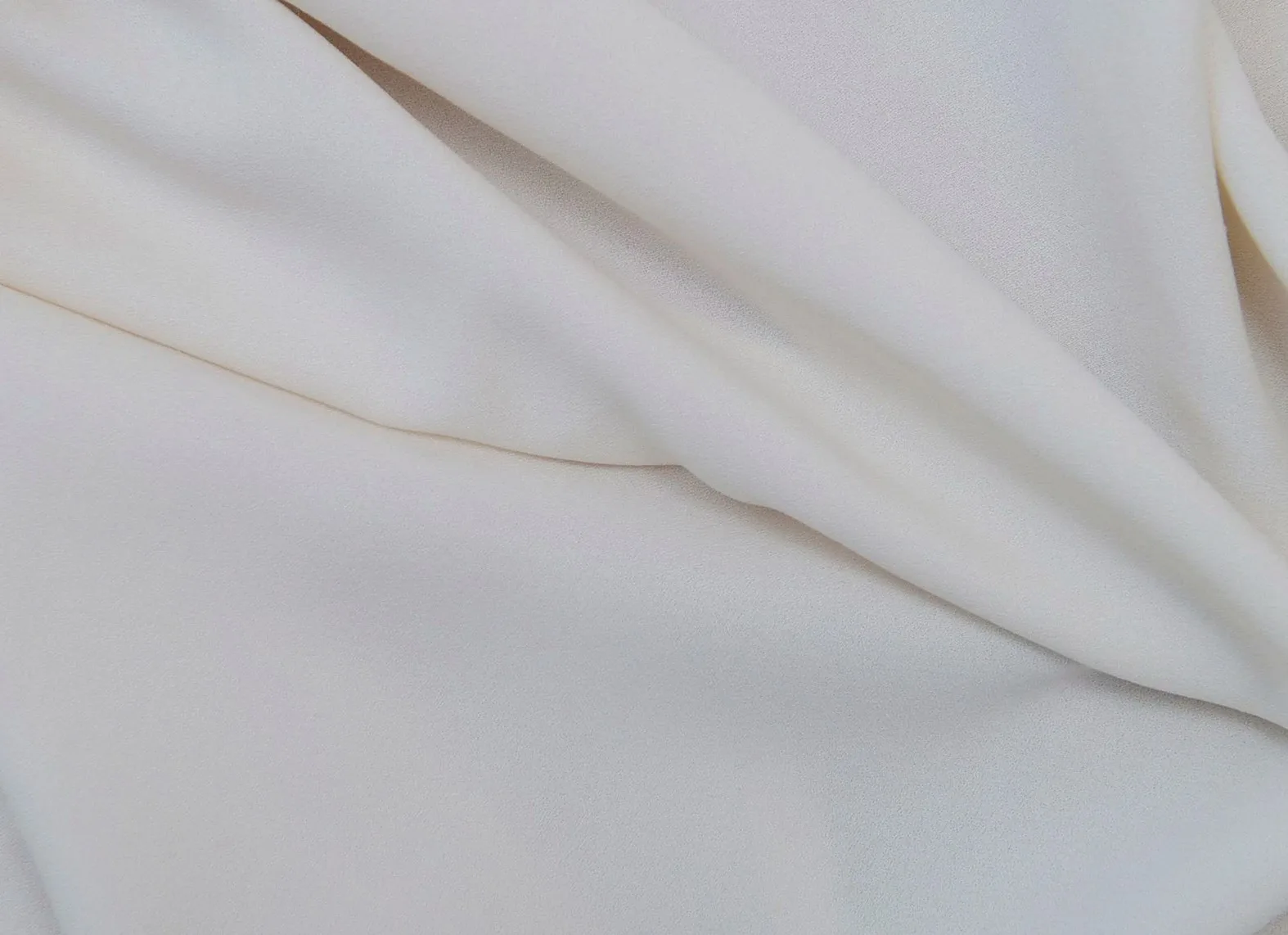 Soft folds of cream-coloured fabric