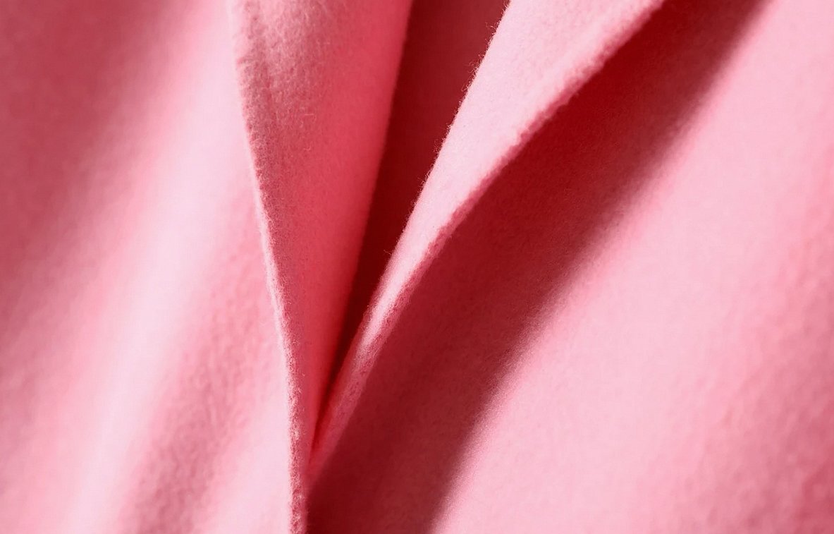 Folds of coral-pink stretch fabric